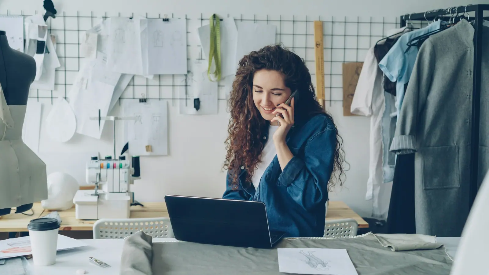 Small-business owner taking a customer call at her studio desk
