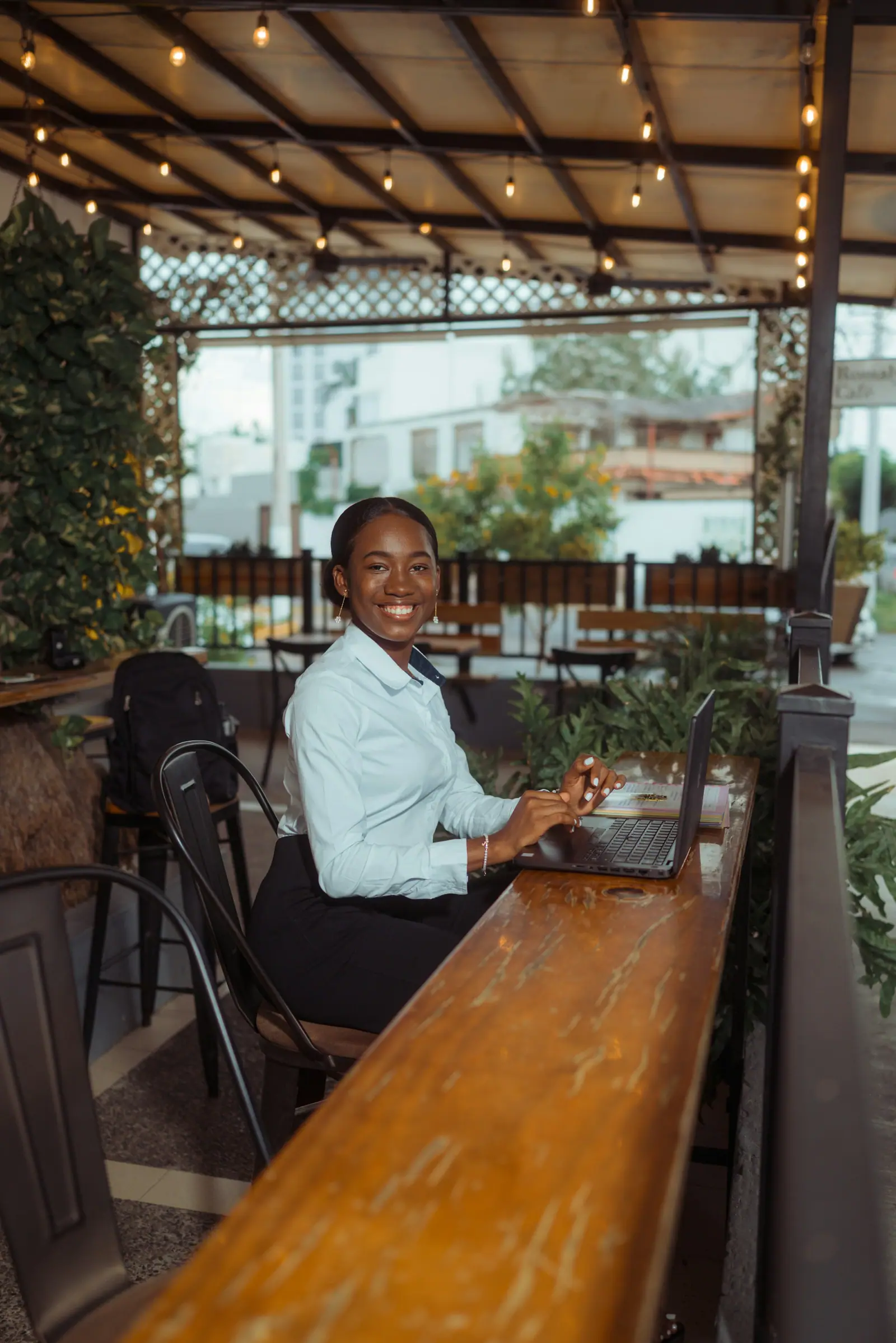 Business owner smiling while reviewing her launch on a laptop