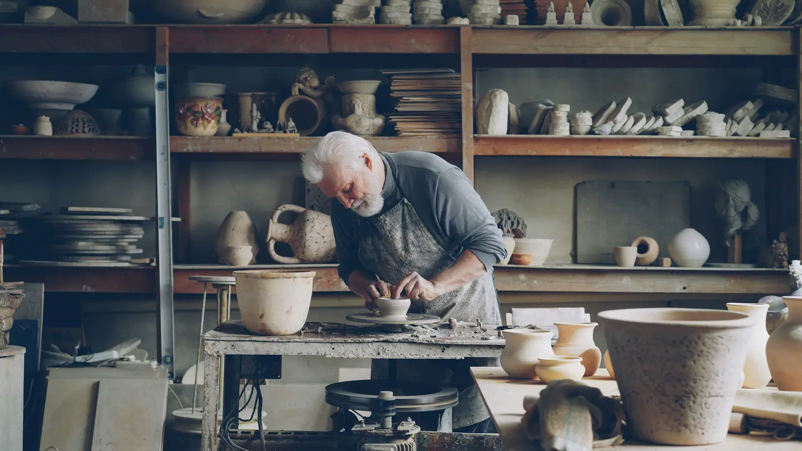 Potter shaping a bowl in his workshop